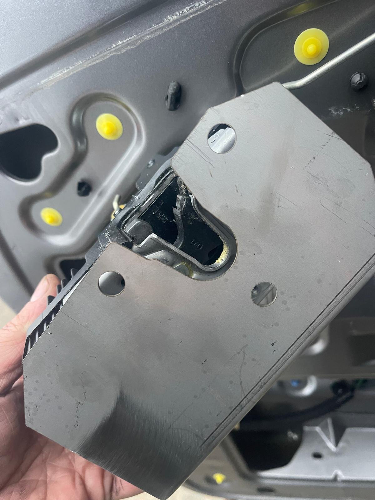 Van door latch assembly removed during a damage repair